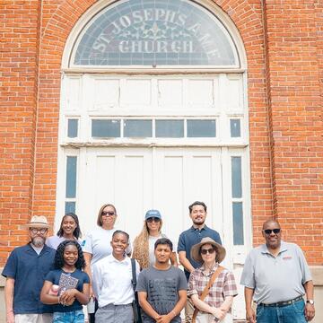 The 2026 HOPE Crew fellowship cohort standing on the steps of St. Joseph’s A.M.E. Church