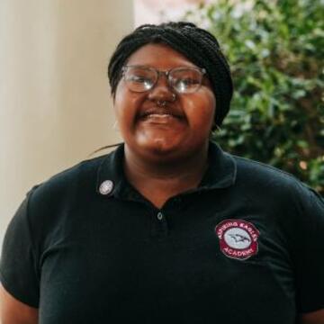 Portrait of Brooke Johnson smiling and wearing a black NCCU polo shirt.