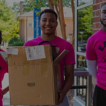 Eagle move-in crew holding a box