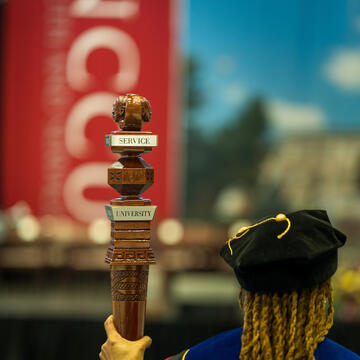 NCCU Faculty Marshall carrying the official NCCU Mace