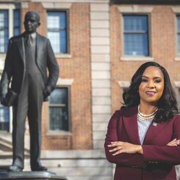 Chancellor Dixon standing beside Dr. Shepard statue