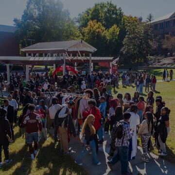 Large group of students gathered outdoors at a campus event