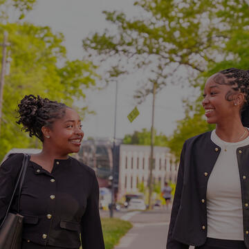 Business students walking together, smiling