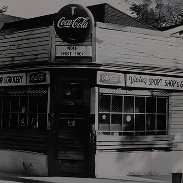 Black-and-white photo of Viola’s Sport Shop & Grocery with Coca-Cola signage on the storefront.