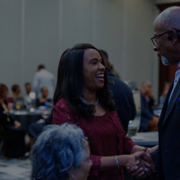Photo of two people shaking hands at a nccu reception.