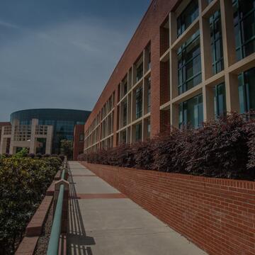 Exterior view of North Carolina Central University's School of Education with a brick walkway leading to the entrance.