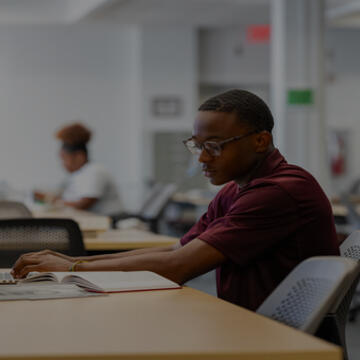 Image of man sitting at desk studying 