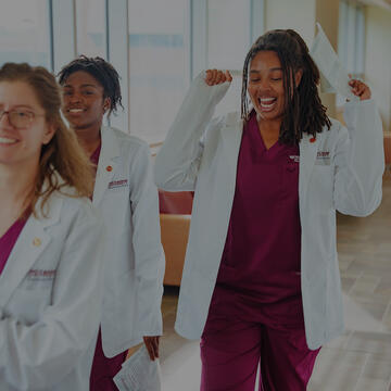 Nursing students walking in a hallway