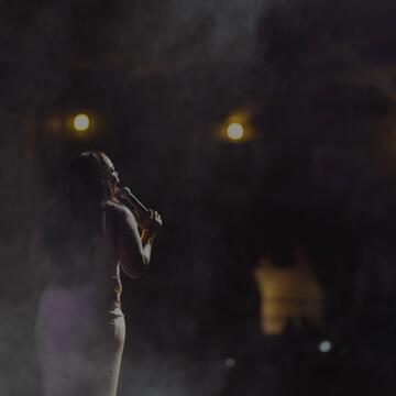 Image of a woman singing at a talent show
