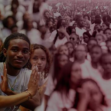 North Carolina Central University students showcase Eagle pride and school spirit during a campus gathering, featuring smiling students in white NCCU shirts against a large crowd of fellow Eagles.
